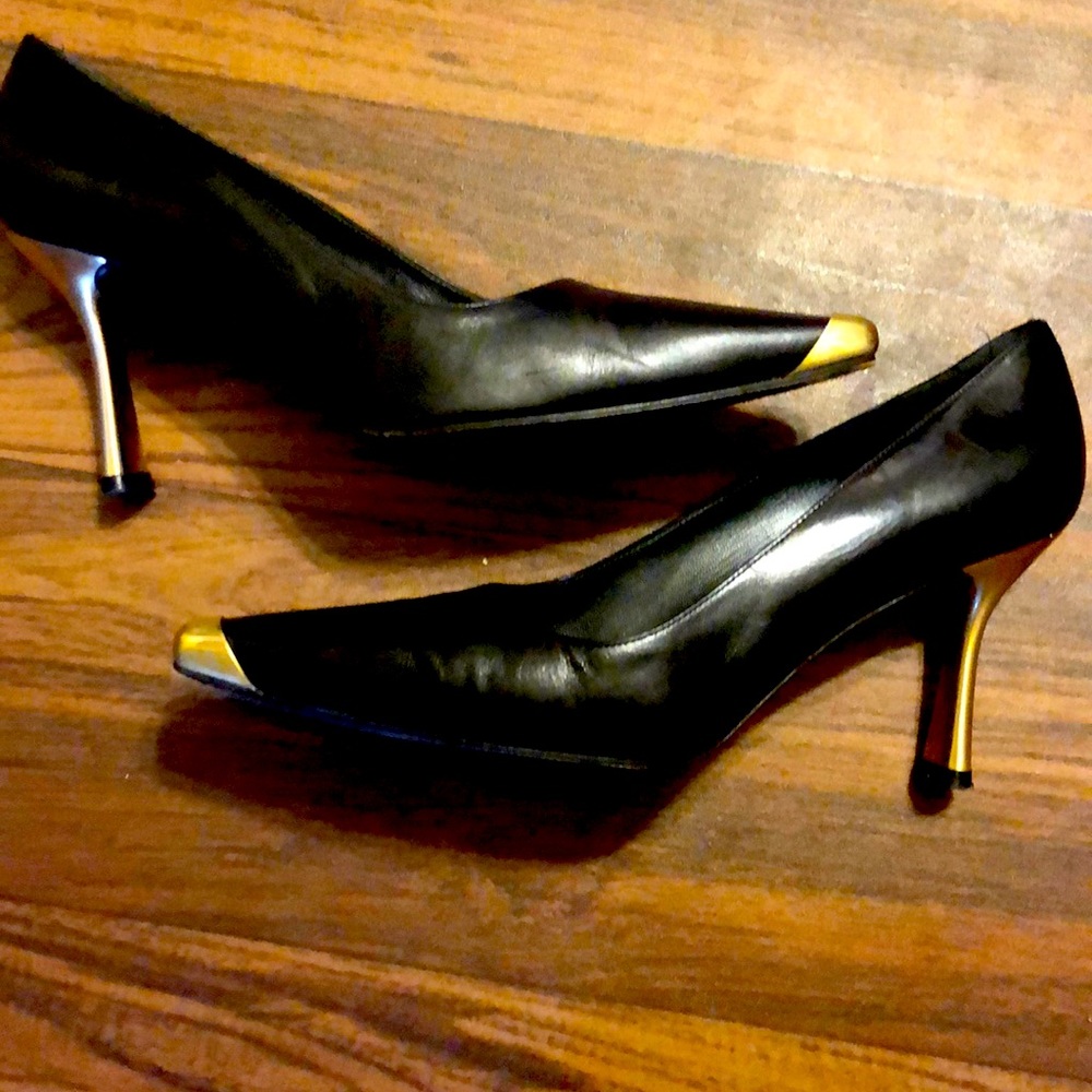 Black leather heels with gold toe and heel